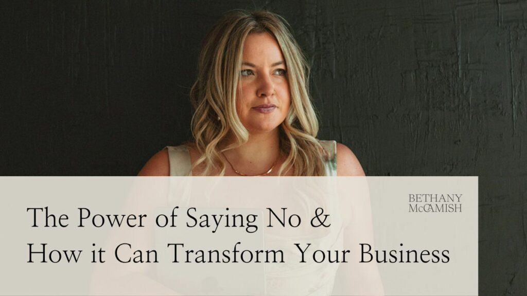 A woman standing against a dark colored wall looking off to the side. On top is a tan box with text that reads "The power of saying no & how it can transform your business".